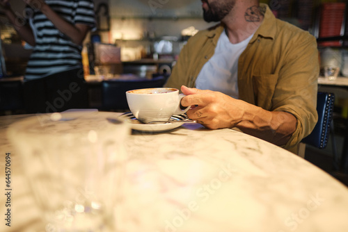 Young man drinking coffee calmly