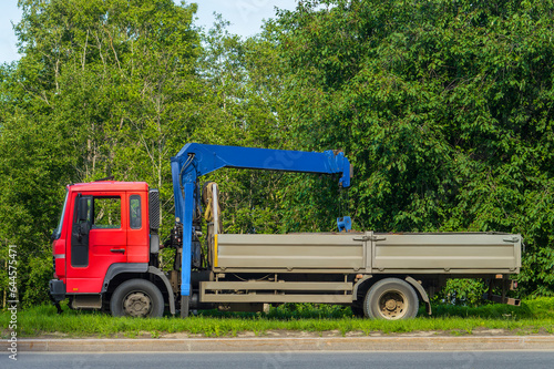 flatbed truck with blue crane arm. High quality photo