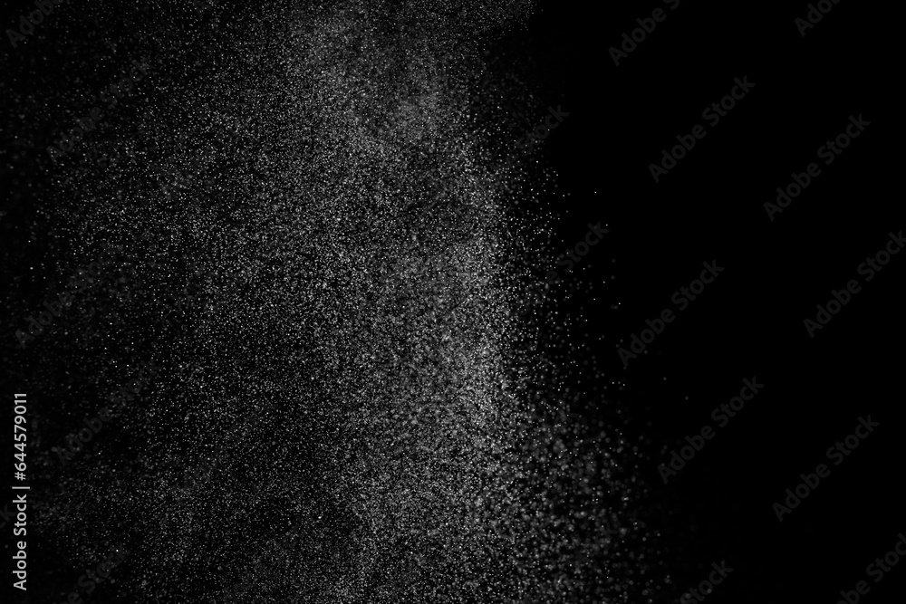 Abstract splashes of water on black background. Freeze motion of white particles. Rain, snow overlay texture. Abstract splashes of water on black background. Freeze motion of white particles. Rain, snow overlay texture.