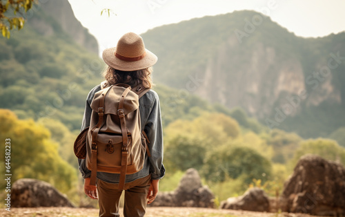 Young traveler wearing a hat with backpack hiking outdoor Travel Lifestyle and Adventure concept