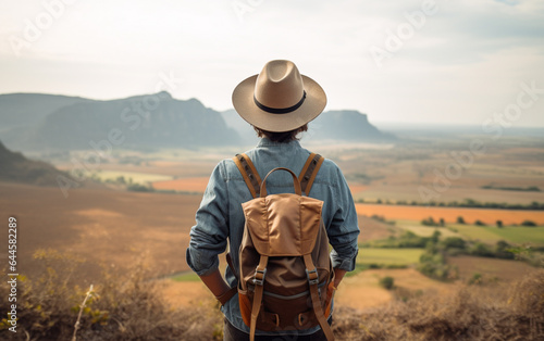 Young traveler wearing a hat with backpack hiking outdoor Travel Lifestyle and Adventure concept