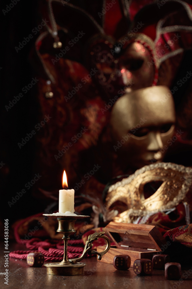 Burning candle, dice, and carnival masks. Burning candle, dice, and carnival masks.