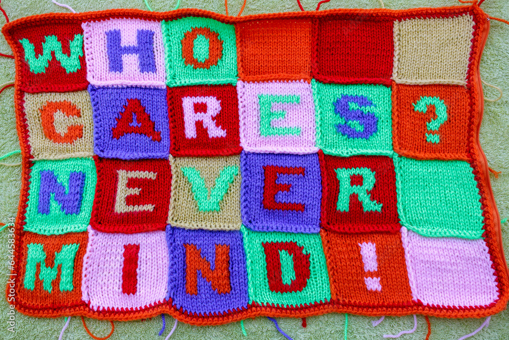 Hand knitted fabric with multi colored careless phrases Hand knitted fabric with multi colored careless phrases
