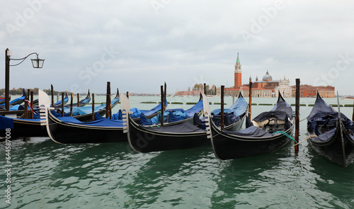 gondolas moored in the Venetian lagoon in Venice Italy