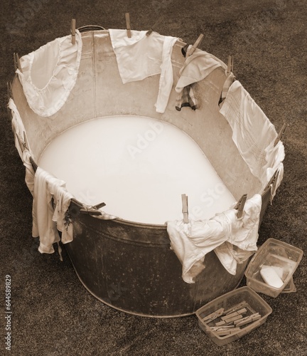 Slika na platnu washtub with clothespin and clothes with old toned sepia effect