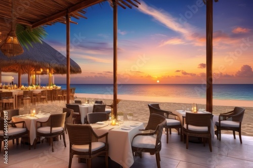 Outdoor restaurant at the beach. Table setting at tropical beach restaurant. beautiful sunset sky  sea view. Luxury hotel or resort restaurant