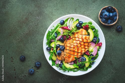 Fotografie Delicious salad with blueberries, grilled chicken, avocado, red onion, walnuts,