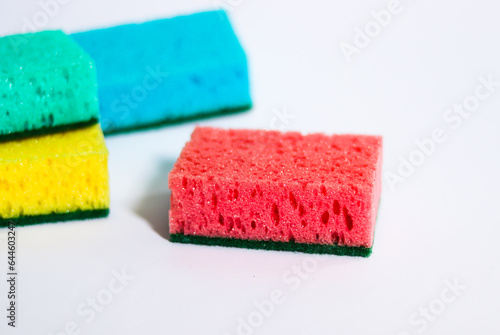 Colored sponges for dishes on a white background.