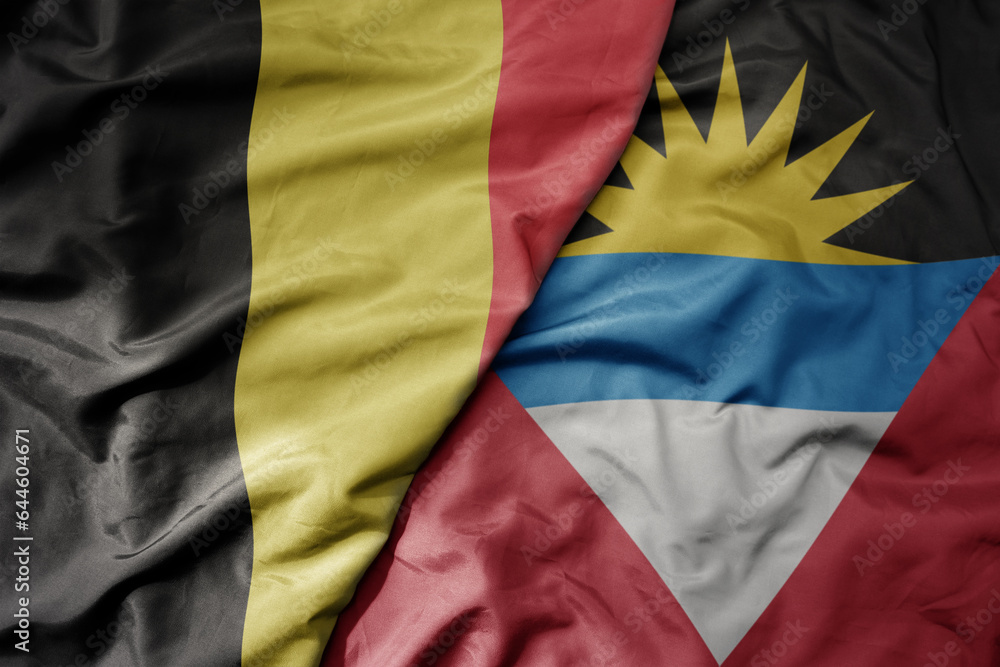 big waving national colorful flag of belgium and national flag of antigua and barbuda . big waving national colorful flag of belgium and national flag of antigua and barbuda .