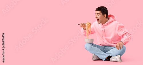 Young man eating Chinese no...