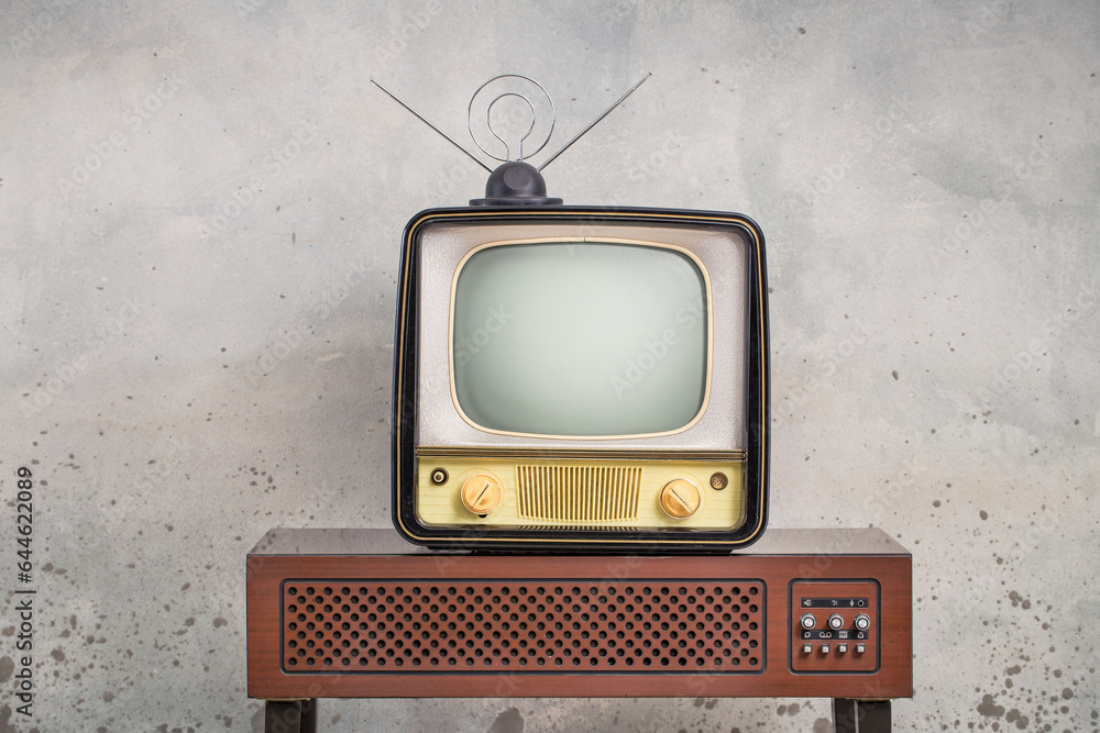 Old retro classic analog TV set and aged wooden television outdated