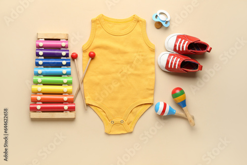 Composition with baby clothes and accessories on color background