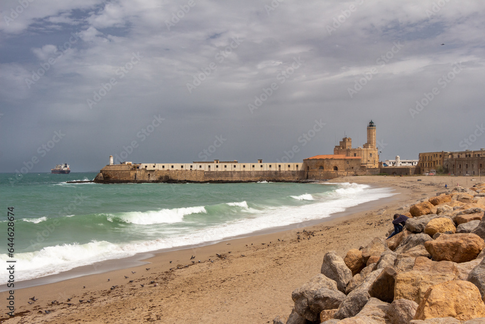 The Lighthouse of the Admiralty in Algiers, Alger, Algeria. View from the beach. Stormy weather and huge waves in the Mediterranean sea. The Lighthouse of the Admiralty in Algiers, Alger, Algeria. View from the beach. Stormy weather and huge waves in the Mediterranean sea.