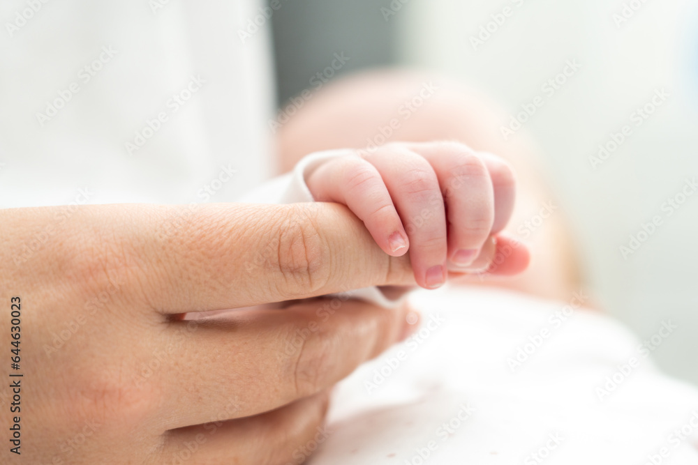 Newborn finds solace in mother's touch. Concept of unspoken promises and protection Newborn finds solace in mother's touch. Concept of unspoken promises and protection