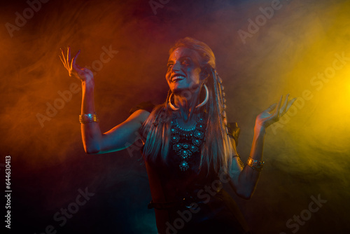 Photo of cool crazy woman wear gothic valkyrie costume dancing ritual music isolated orange fog background