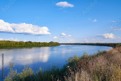 Landscape with river and blue sky with white clouds