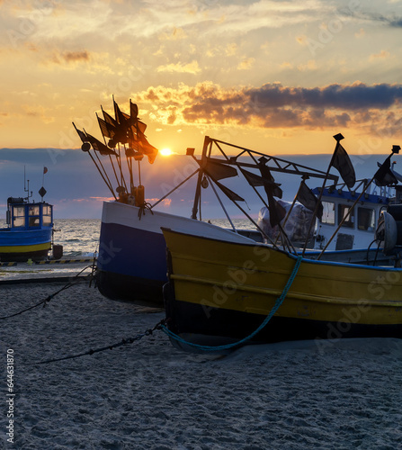Fishing boats on the beach at sunset: Baltic Sea, Western Pomerania, Poland, Europe.