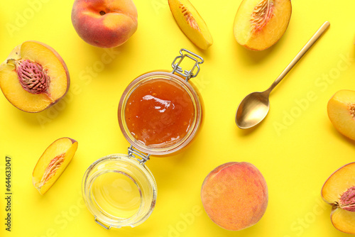 Fototapeta Naklejka Na Ścianę i Meble -  Composition with jar of sweet peach jam and fresh fruits on yellow background