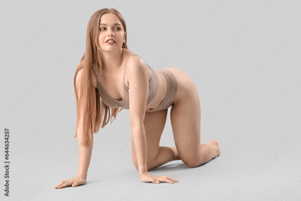 Naklejka premium Beautiful woman in underwear on light background