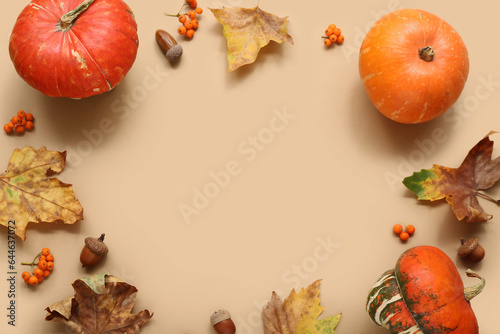 Cuadro en lienzo Frame made of pumpkins with viburnum and acorns on beige background