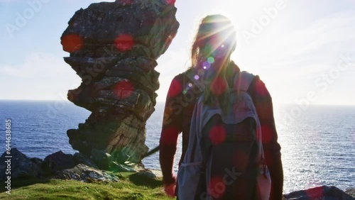 Woman walking towards unique rock structre. Hag's head photo