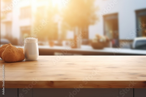 Picture of table with cup of coffee and croissant on it. Perfect for showcasing breakfast or coffee shop themes.