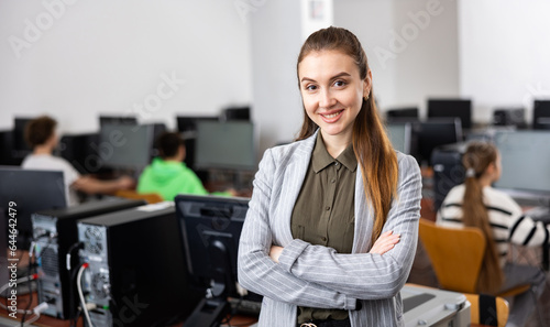 Portrait of a young smiling female computer class teacher at school