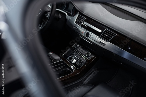 Interior of a modern luxury car with a multimedia panel and automatic climate control panel © Daniel Jędzura