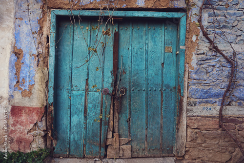 Old, colorful wooden door with lock - fairytale door to a world of fantasy
