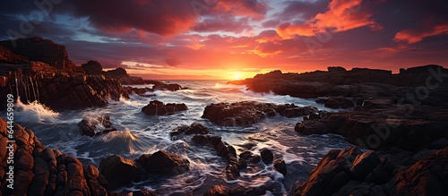 Dramatic and peaceful image of a sunset over a rocky shore AI Generated
