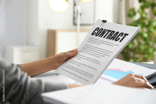 Fotografie Government contract. Woman reading document at table, closeup