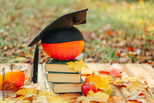 Back to school .Study and education.Student hat on pumpkin and stack of books. Start school and college season concept.