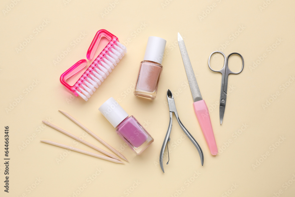 Set of pedicure tools on beige background, flat lay Set of pedicure tools on beige background, flat lay