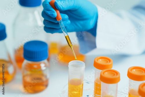 Close-up of laboratory technician conducting rigorous oil test, ensuring product integrity and safety, oil sample for quality control and purity testing, advancing petrochemical knowledge