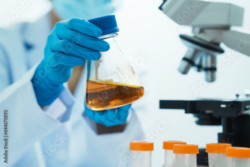 Close-up of laboratory technician conducting rigorous oil test, ensuring product integrity and safety, oil sample for quality control and purity testing, advancing petrochemical knowledge photo