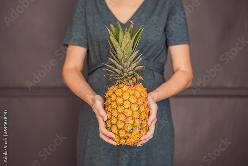 A pregnant woman's belly, beautifully showcasing the size of her baby, likened to a pineapple. Explore the potential benefits and harms of pineapple during pregnancy and childbirth photo