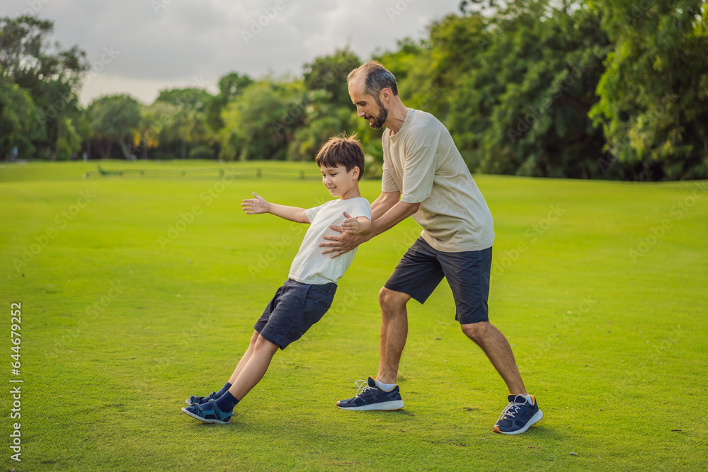 A touching trust exercise as a son falls back into his father's arms, demonstrating unwavering trust and the bond between parent and child