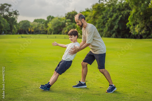 Obraz na płótnie A touching trust exercise as a son falls back into his father's arms, demonstrating unwavering trust and the bond between parent and child w salonie