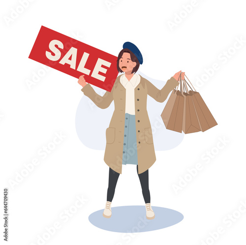 Seasonal Shopping Spree. Autumn Sale. Full-Length Stylish Woman Holding Sale Sign with Shopping Bags. Happy Shopper with Autumn Discounts © Thidarat