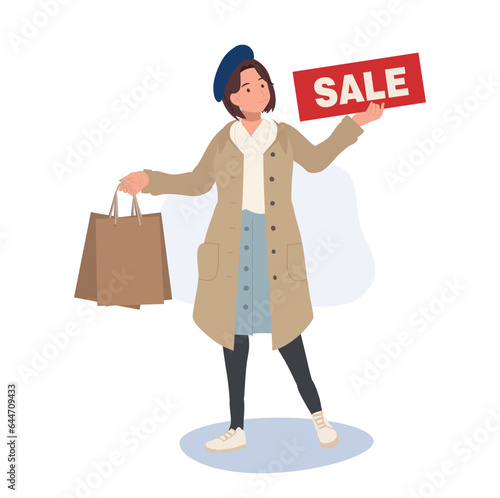 Seasonal Shopping Spree. Autumn Sale. Full-Length Stylish Woman Holding Sale Sign with Shopping Bags. Happy Shopper with Autumn Discounts