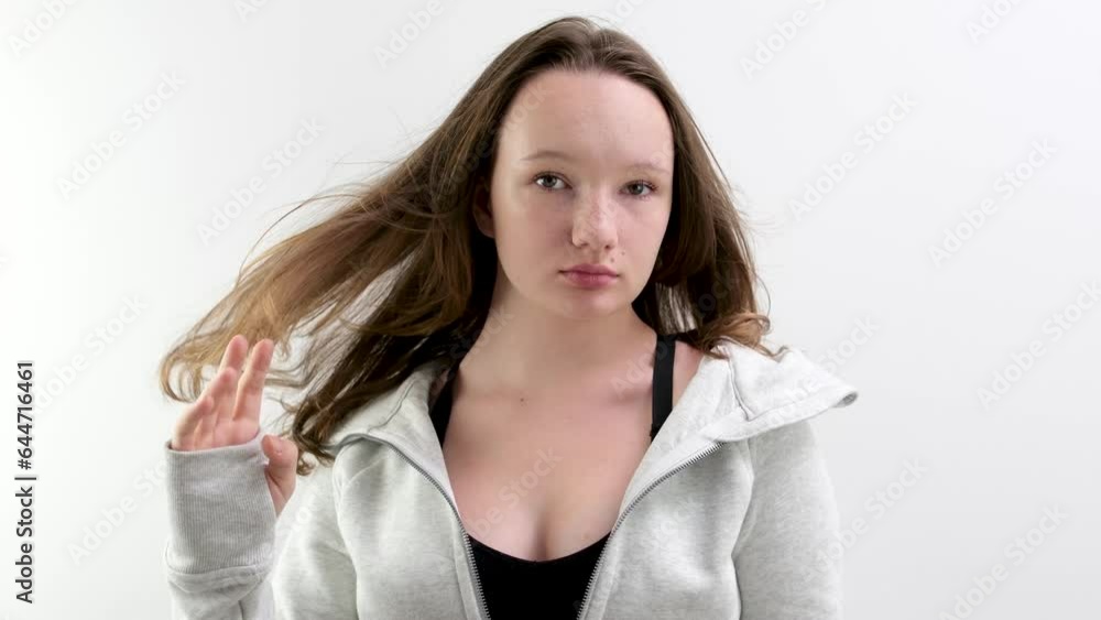 young mixed race woman in studio touches her stright shiny hair. High quality 4k footage young mixed race woman in studio touches her stright shiny hair. High quality 4k footage