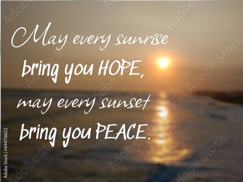 Motivational quote "May every sunrise bring you hope, may every sunset bring you peace" on nature background. Beautiful sunset above sea horizon, with sun reflection on the water.