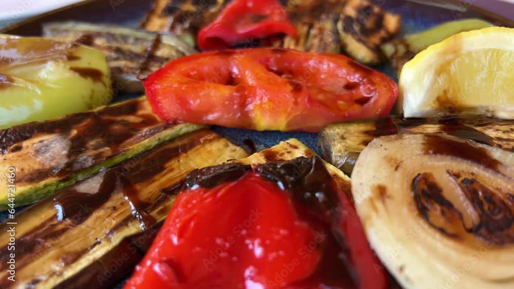 black ceramic plate with sliced grilled vegetables onto kitchen table. High quality 4k footage black ceramic plate with sliced grilled vegetables onto kitchen table. High quality 4k footage