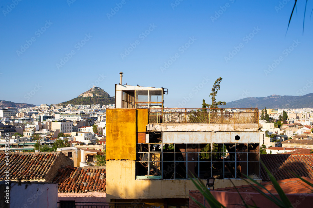 Fototapeta premium Old ruined building in top of Plaka district as seen in Athens skyline