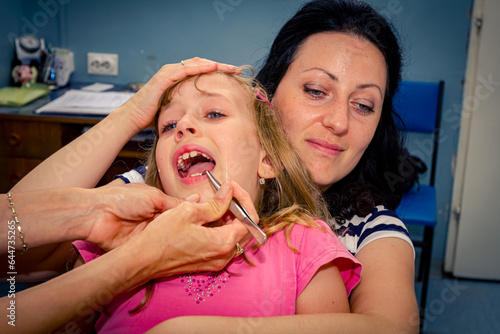 Frightened sweet little girl at dentist, dental care