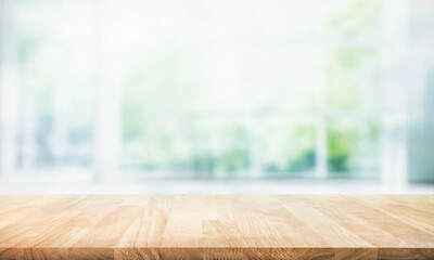 Selective focus.Empty of wood table top on blur of curtain with window and green from garden background.For montage product display or design key visual layout