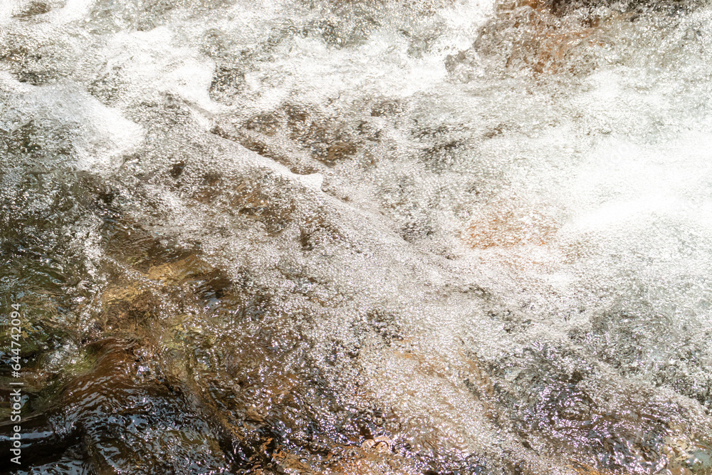 Water flowing over rocks in a stream, after some edits.