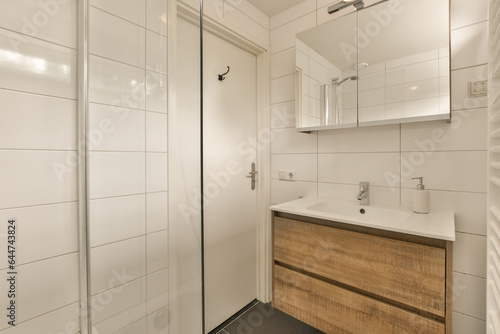 Wallpaper Mural a bathroom with white tiles on the walls and wood cabinetd vanity in the corner, next to a glass shower door Torontodigital.ca