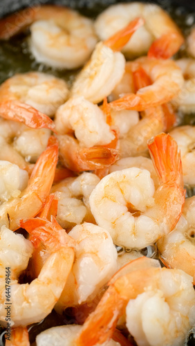 Fresh shrimps fried in oil pan, close up