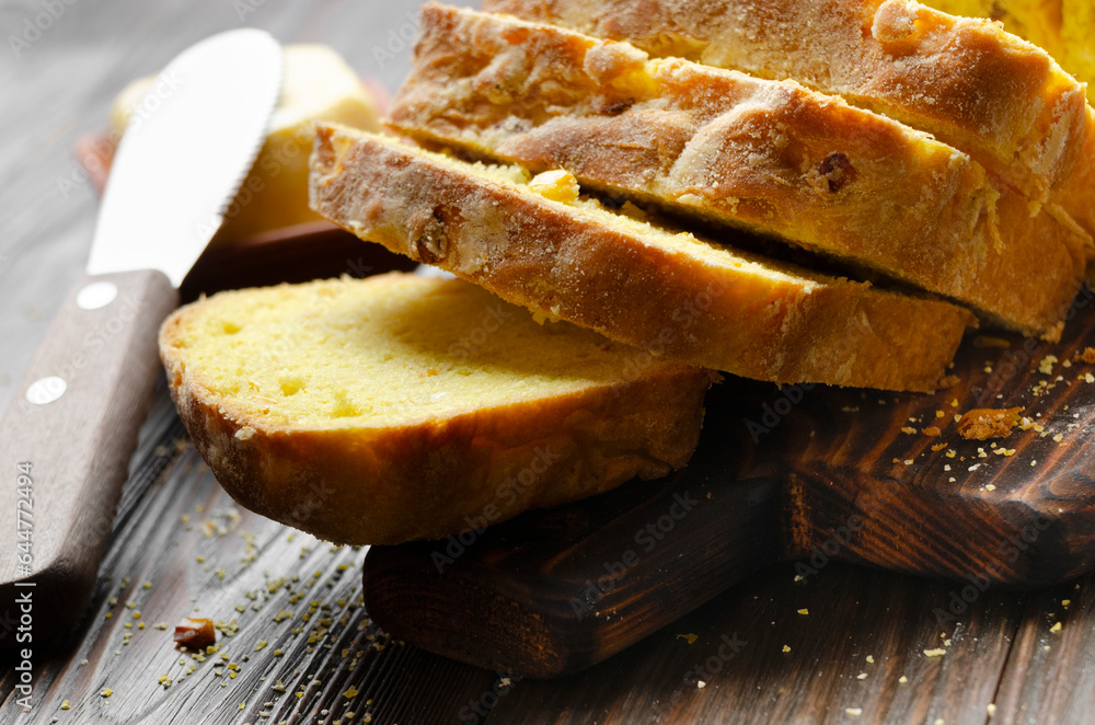 Slices of homemade cornbread and butter on kitchen table